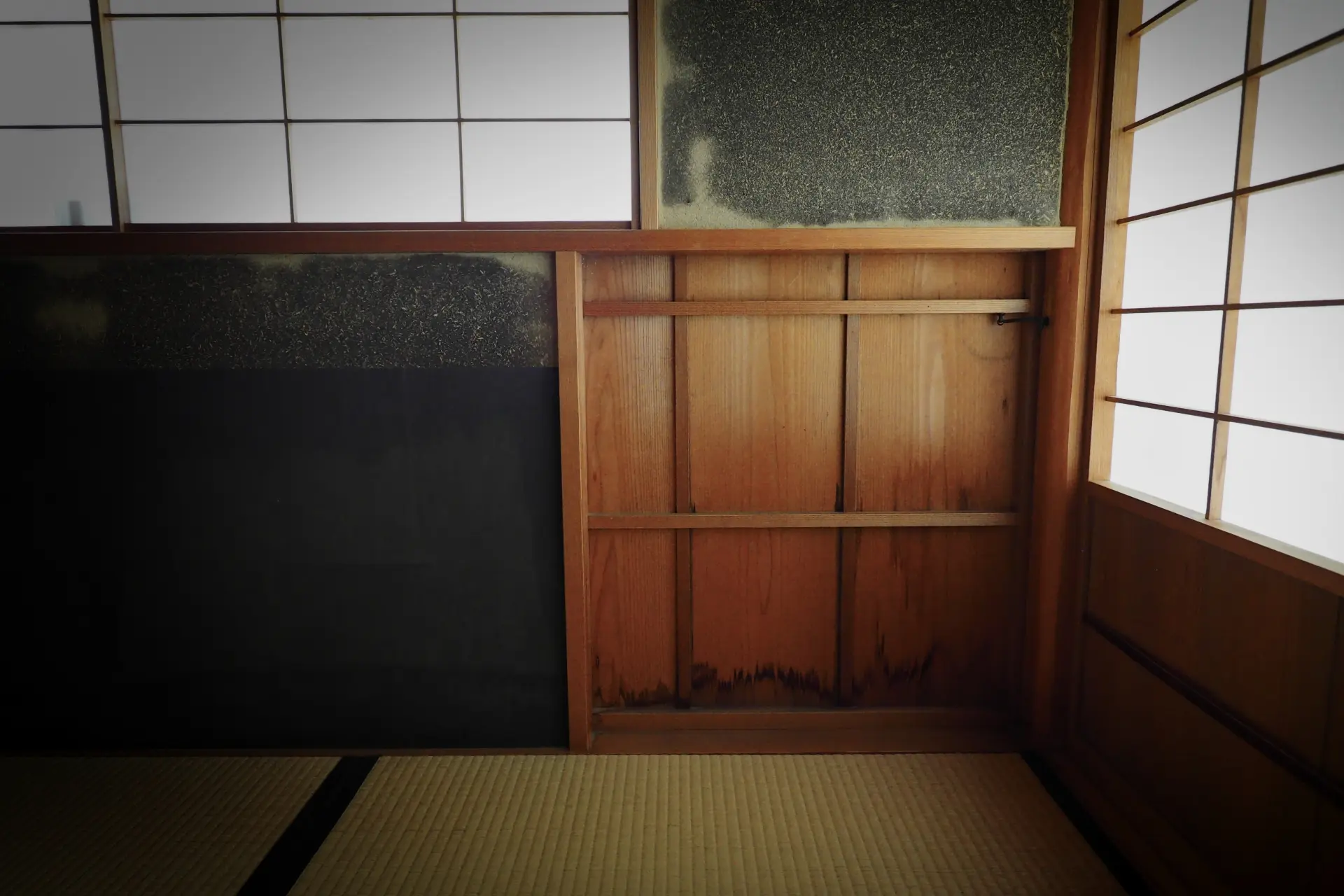 伝統的な日本建築の和室、障子戸と土壁、木の格子状の柱、畳の床が作り出す静寂な空間